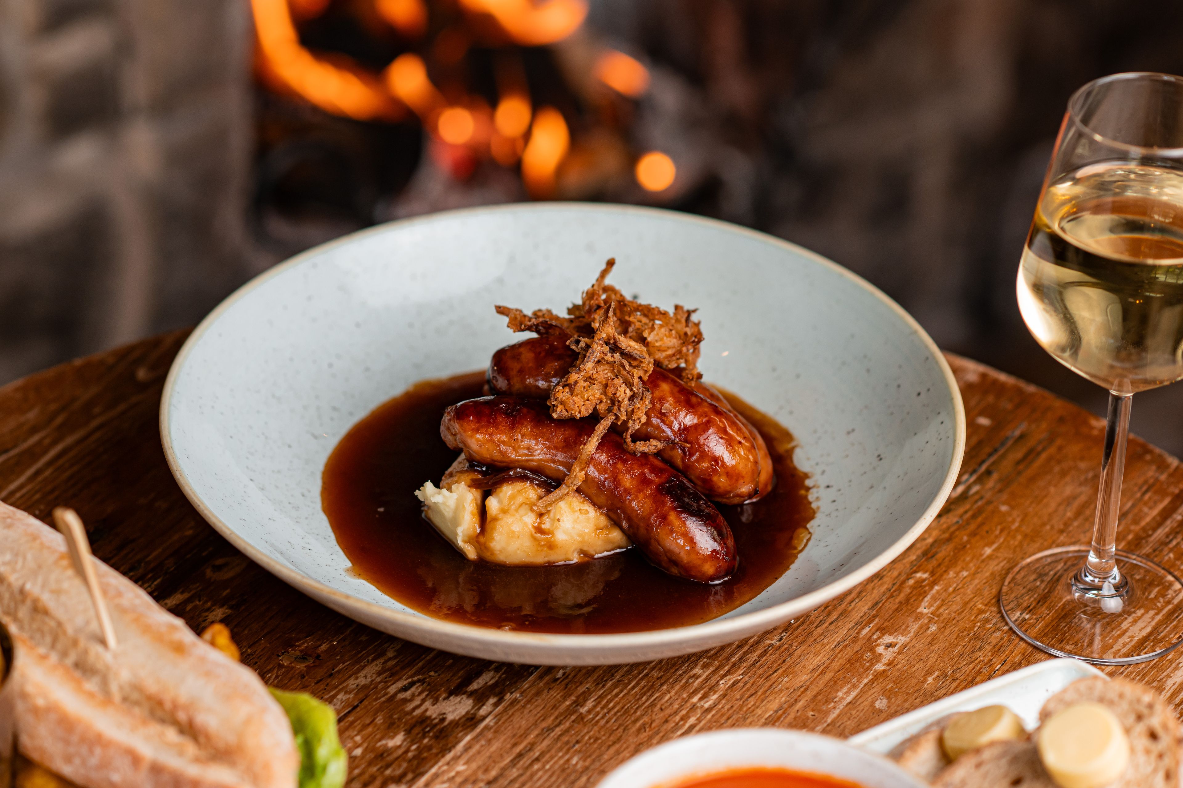 sausage and mash by the fire with a glass of wine