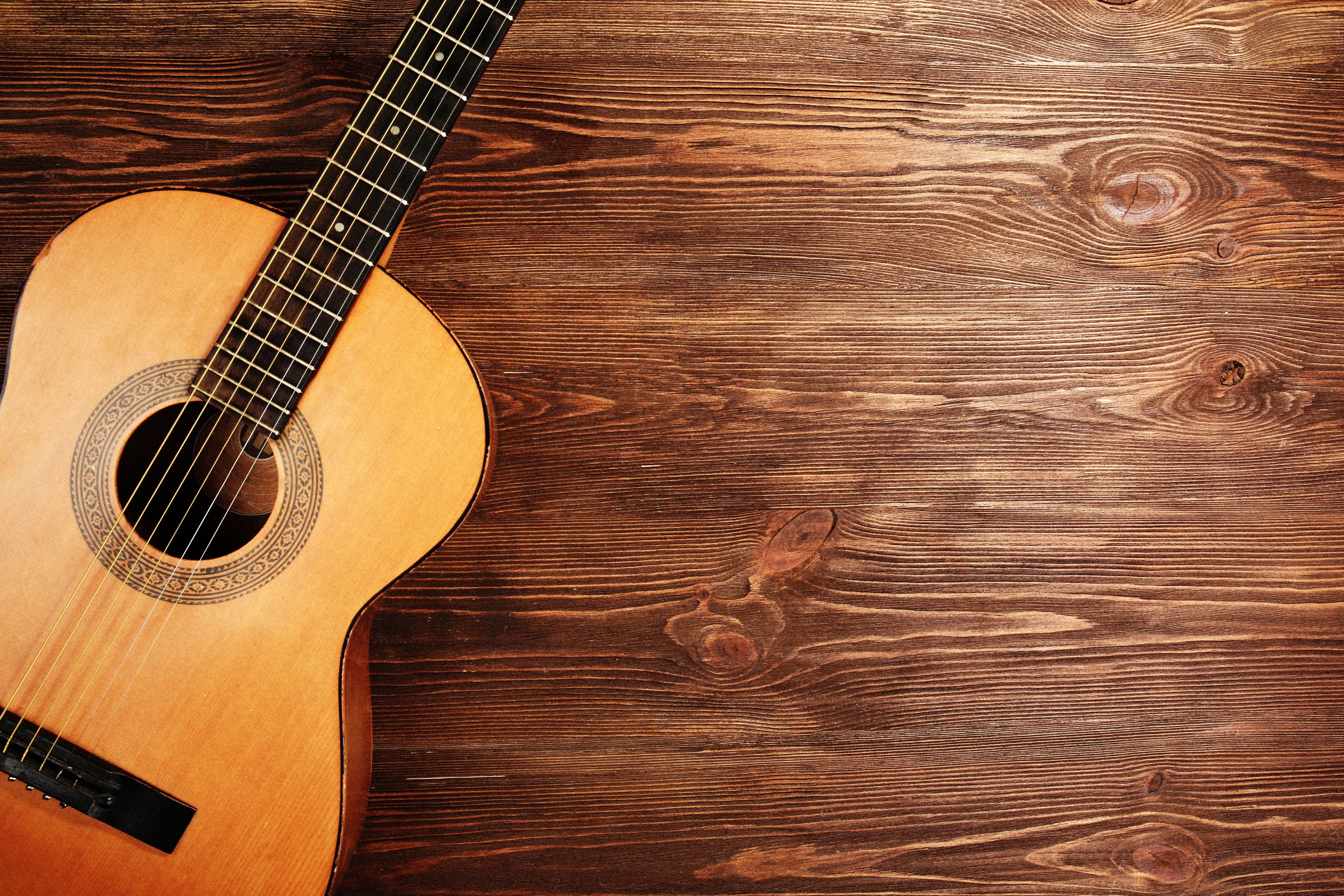 acoustic guitar on wooden flooring